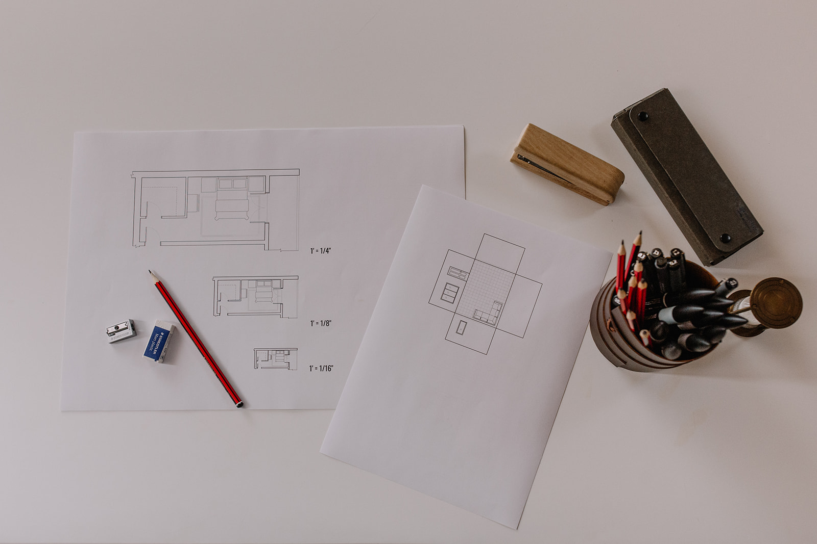 A set of floor plans and elevations on a studio desk