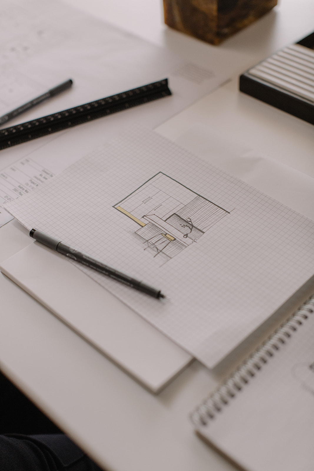 A sketched room concept on grid paper with a fineliner and scale rule